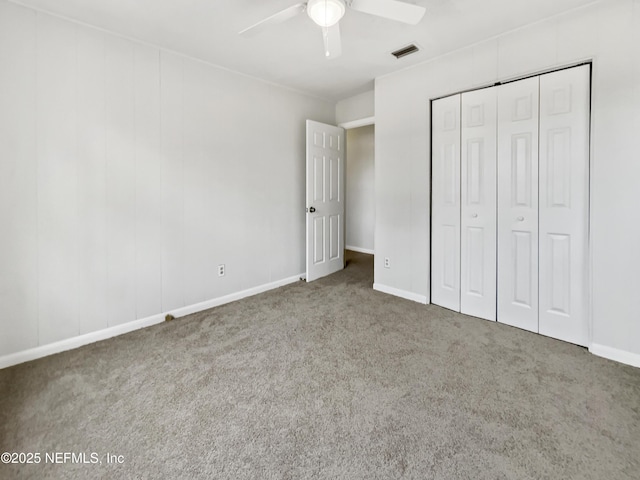 unfurnished bedroom with ceiling fan, a closet, and carpet flooring