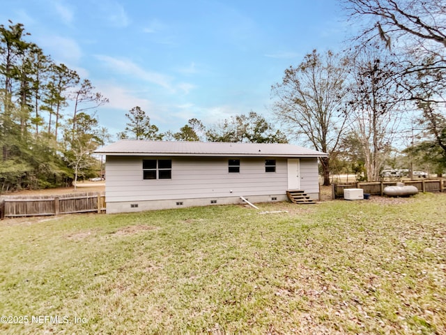 back of property with a lawn