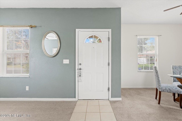 tiled entrance foyer with ceiling fan