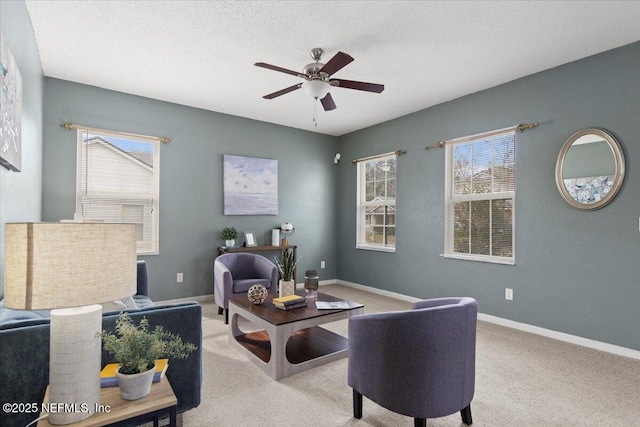 interior space with light colored carpet, ceiling fan, a textured ceiling, and a healthy amount of sunlight