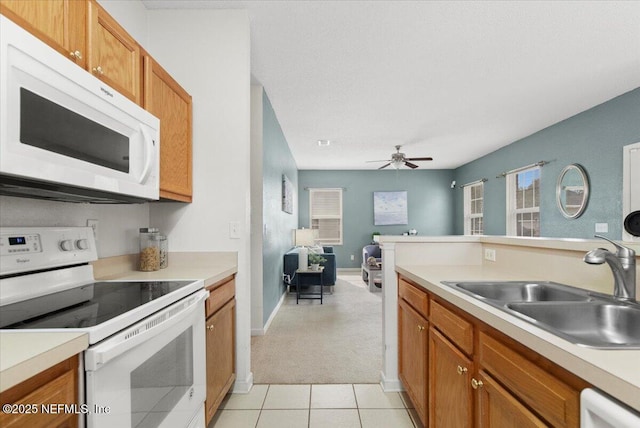 kitchen featuring white appliances, ceiling fan, light tile patterned flooring, and sink