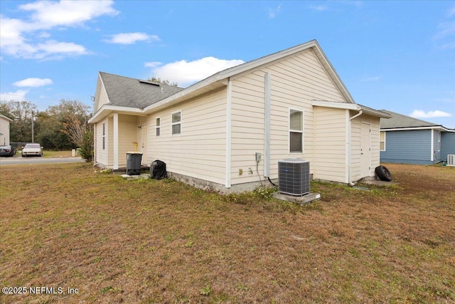 view of property exterior featuring a lawn and central air condition unit