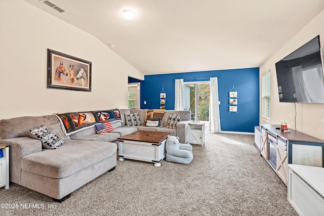 carpeted living room featuring vaulted ceiling