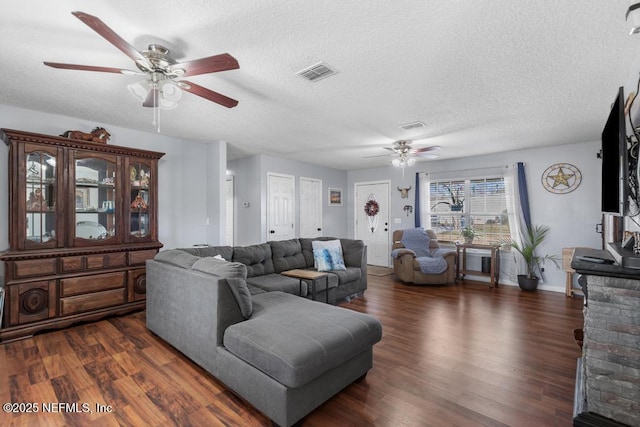 living room featuring a textured ceiling, ceiling fan, and dark hardwood / wood-style floors