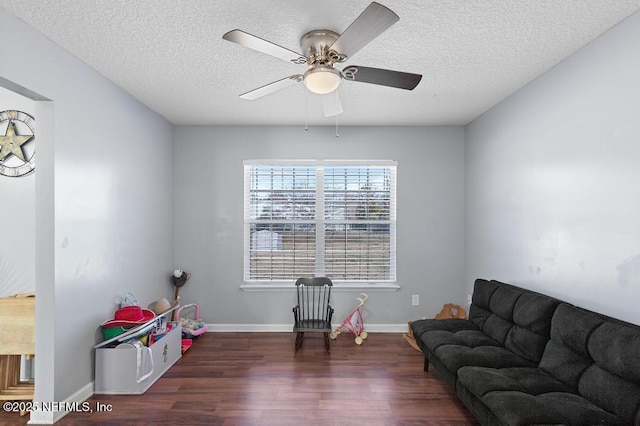 interior space with ceiling fan, dark hardwood / wood-style flooring, and a textured ceiling