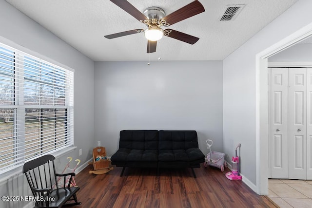 living area featuring ceiling fan and hardwood / wood-style floors