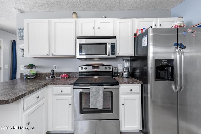 kitchen with white cabinetry, appliances with stainless steel finishes, and kitchen peninsula