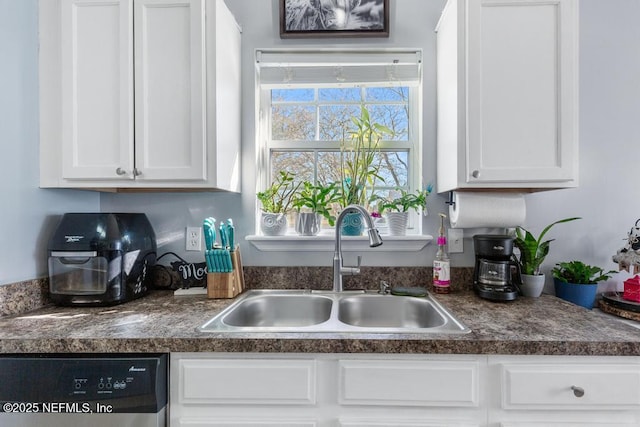 kitchen with dishwasher, sink, and white cabinetry