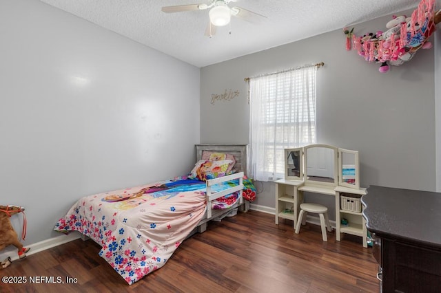 bedroom featuring ceiling fan, dark hardwood / wood-style floors, and a textured ceiling