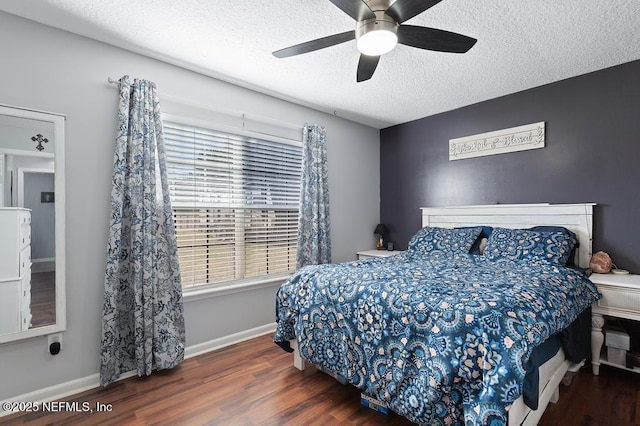 bedroom with ceiling fan, dark hardwood / wood-style floors, and a textured ceiling