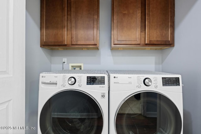 laundry room featuring cabinets and separate washer and dryer