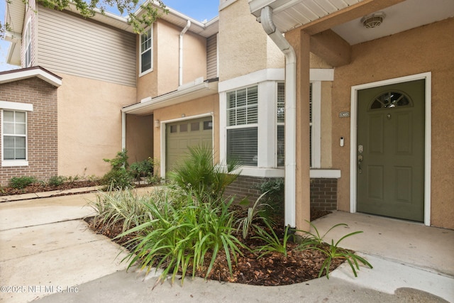 view of exterior entry featuring a garage