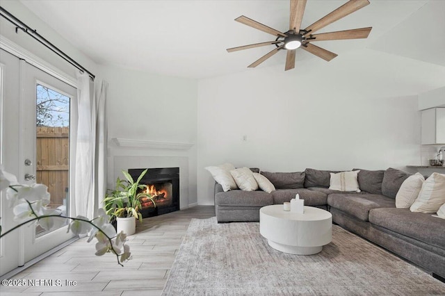 living room with ceiling fan and light wood-type flooring