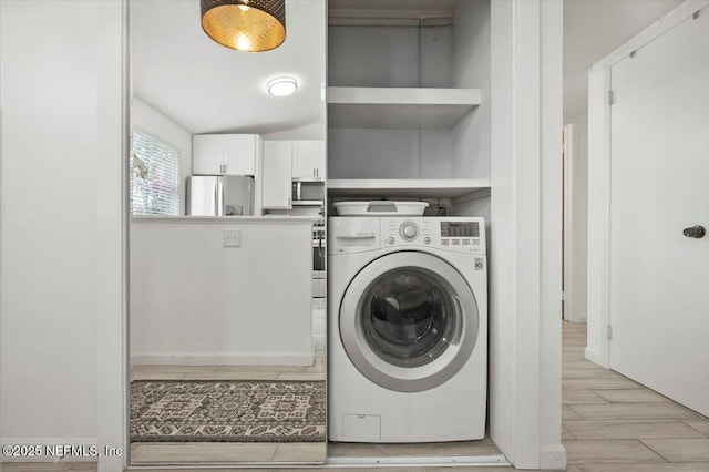 clothes washing area with washer / dryer