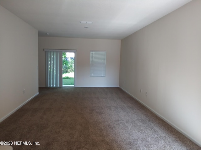 empty room with dark colored carpet