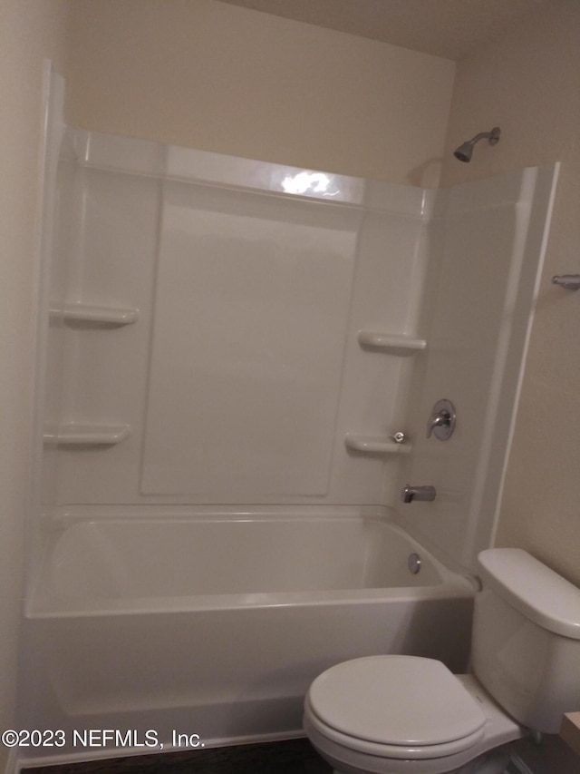 bathroom with toilet and bathtub / shower combination