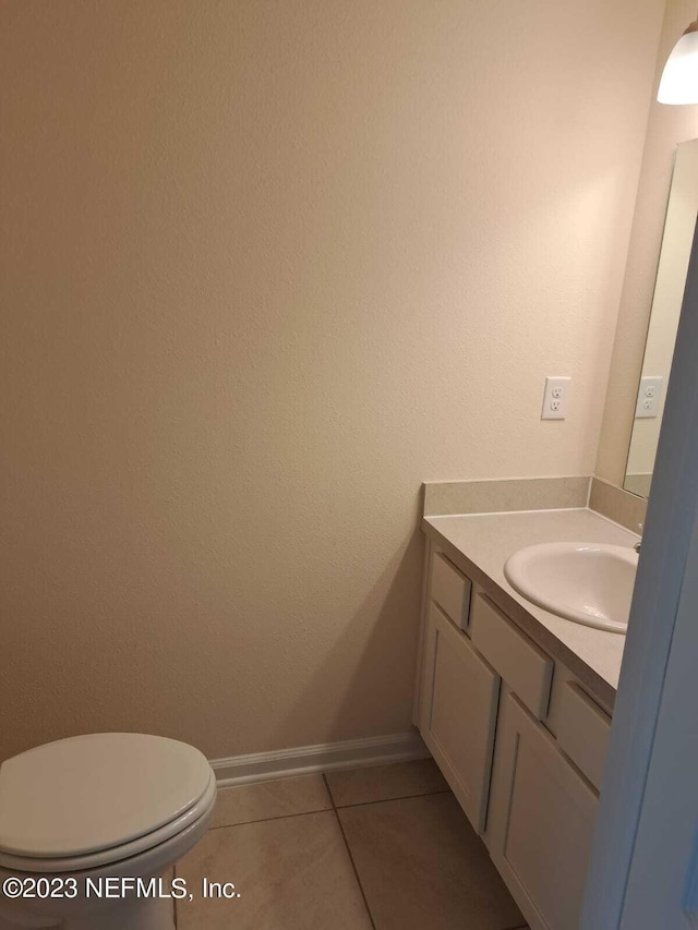 bathroom with vanity, tile patterned floors, and toilet