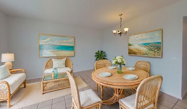 tiled dining room with a chandelier