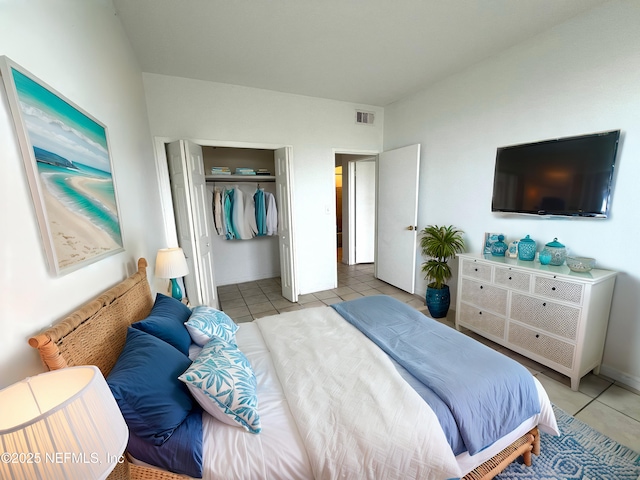 bedroom with a closet and light tile patterned floors