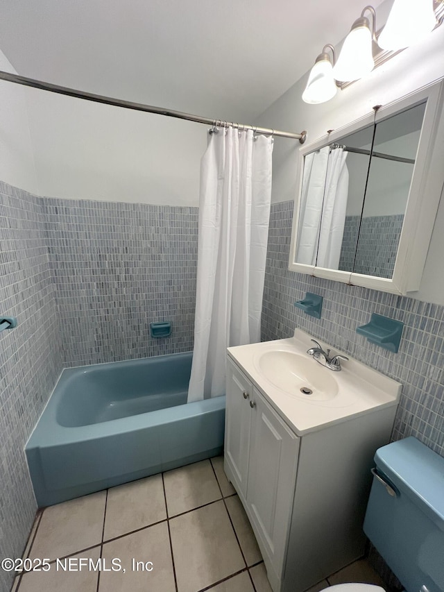 full bathroom featuring shower / tub combo with curtain, tile patterned flooring, tile walls, toilet, and vanity