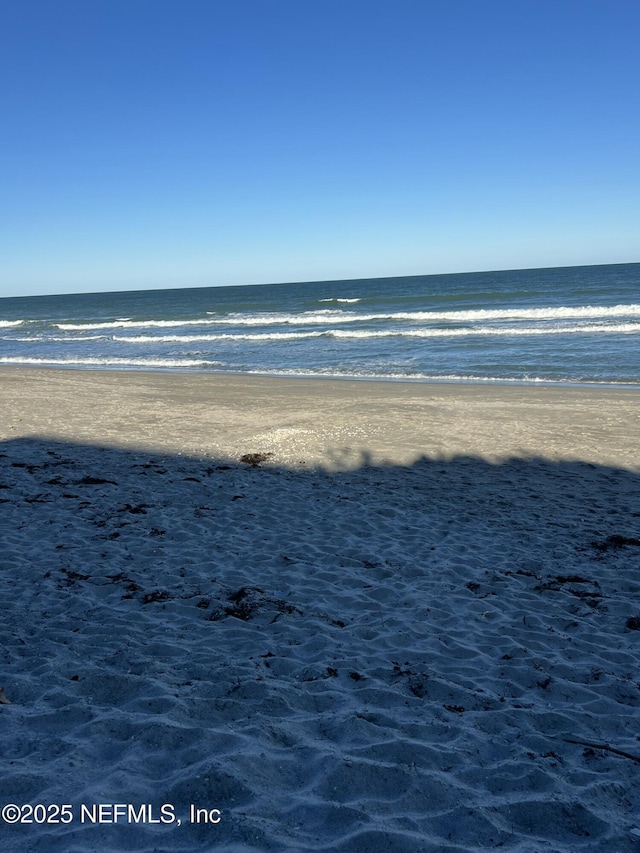 property view of water featuring a beach view