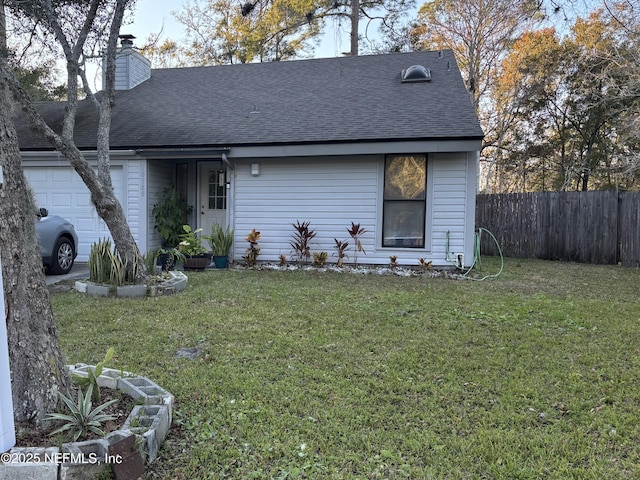 view of front facade with a front lawn and a garage