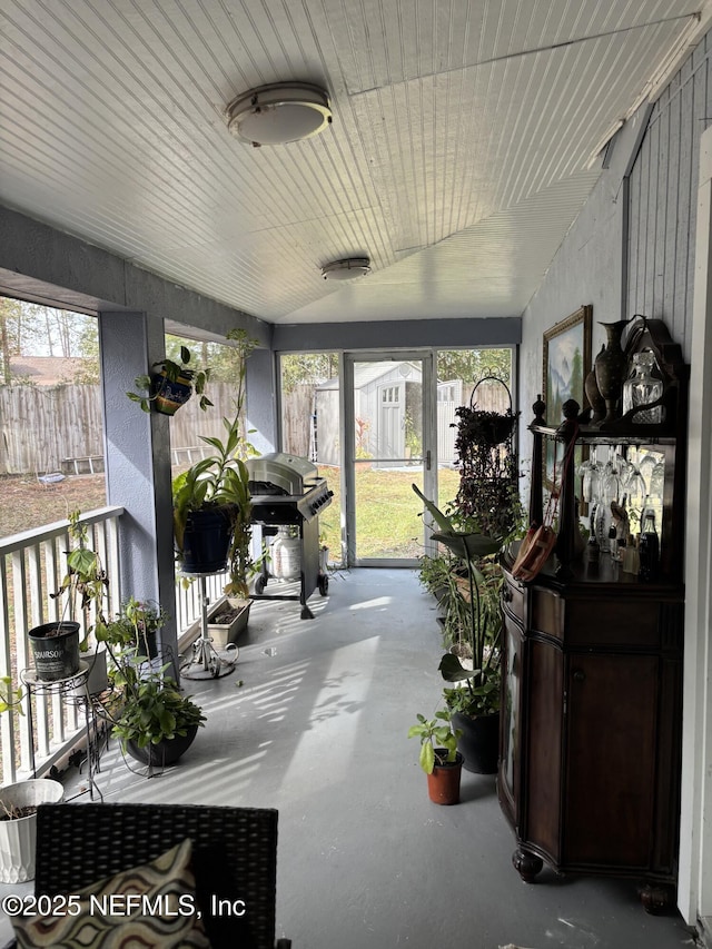 sunroom featuring vaulted ceiling