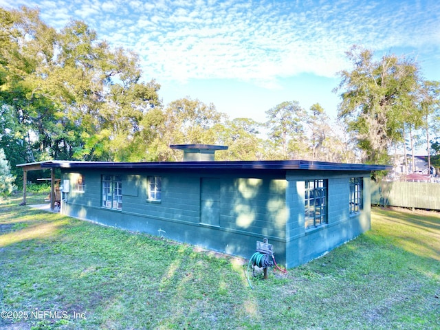 view of side of home featuring a lawn