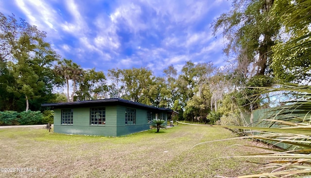 view of side of home featuring a lawn