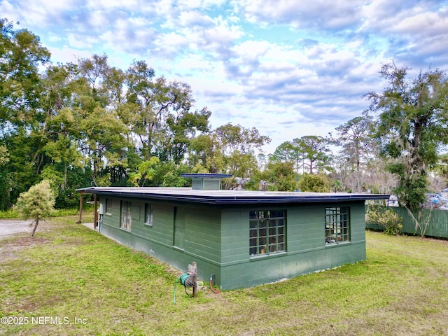 view of side of property with a yard