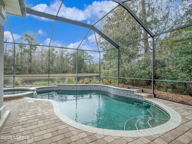 view of swimming pool featuring a lanai, a patio area, and an in ground hot tub