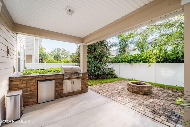 view of patio / terrace featuring an outdoor fire pit and area for grilling