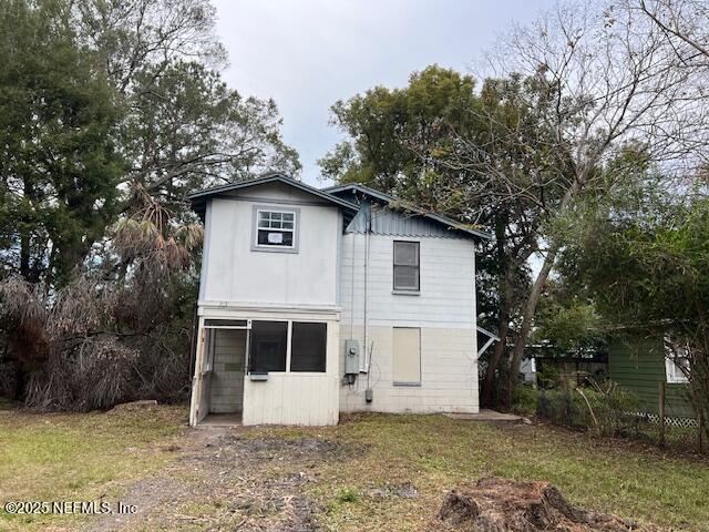 rear view of house with a lawn