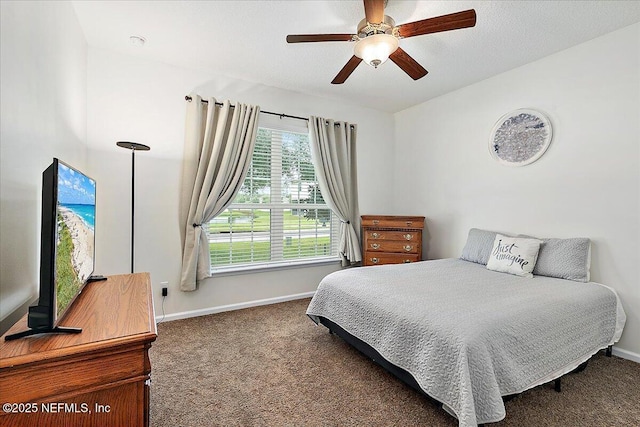 bedroom with dark colored carpet and ceiling fan