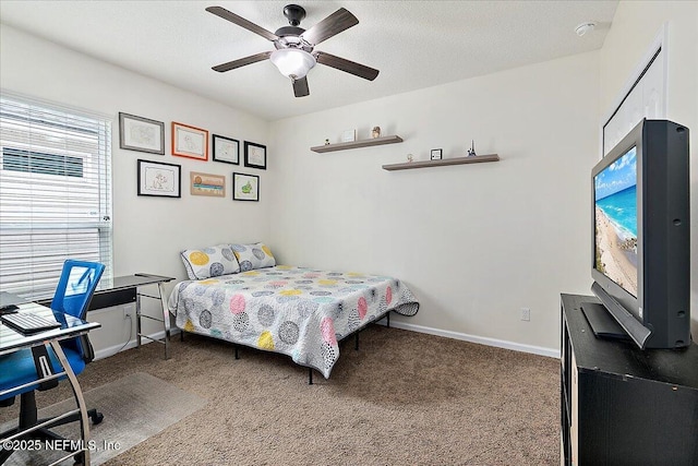 bedroom featuring ceiling fan and carpet