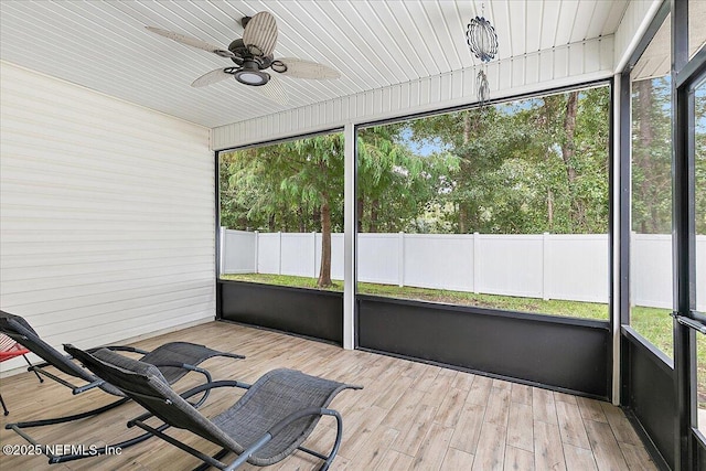 unfurnished sunroom with ceiling fan