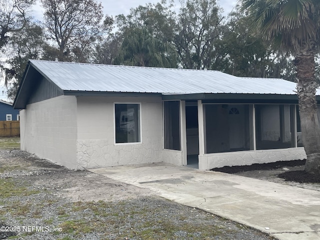 back of house with a sunroom