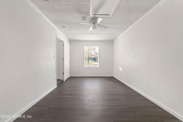 spare room with ornamental molding, dark hardwood / wood-style floors, ceiling fan, and a textured ceiling