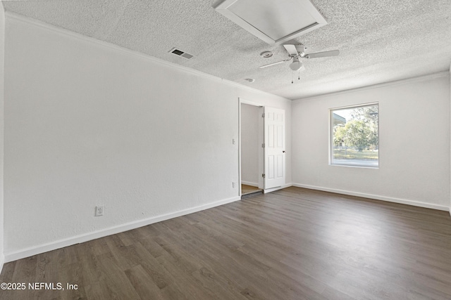 unfurnished room featuring dark hardwood / wood-style flooring, crown molding, and a textured ceiling