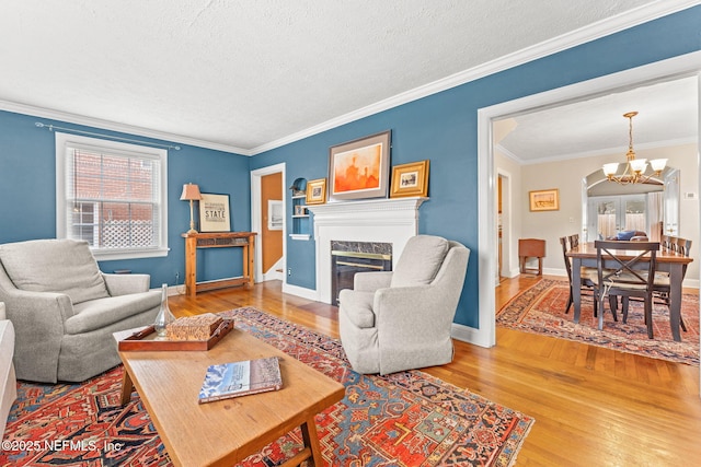 living room featuring a wealth of natural light, a fireplace, and ornamental molding