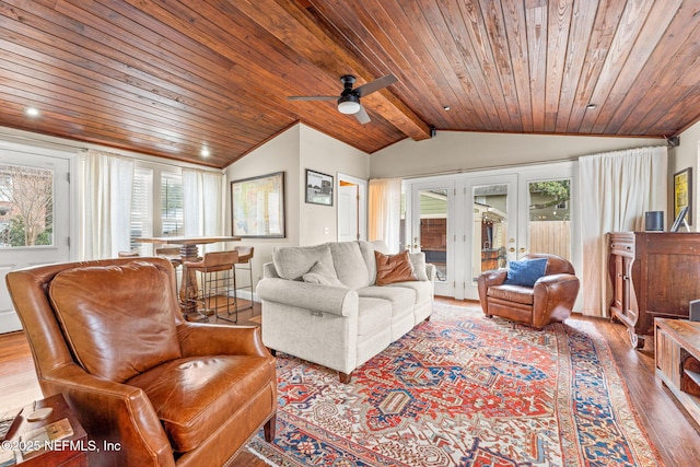 living room with wood ceiling, lofted ceiling with beams, light hardwood / wood-style floors, and plenty of natural light