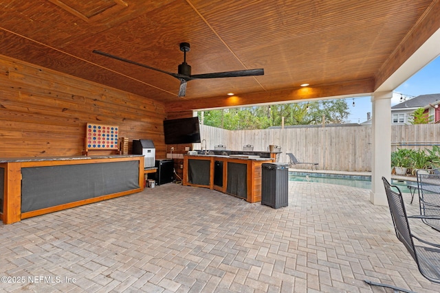 view of patio with area for grilling and ceiling fan