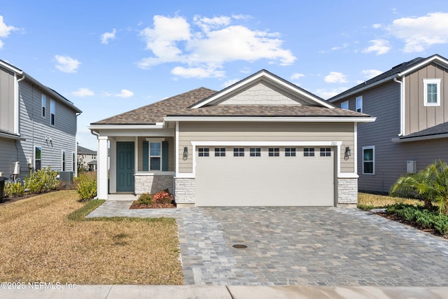 craftsman-style home featuring a front yard, a garage, and a porch