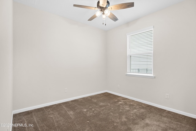 unfurnished room with dark colored carpet, plenty of natural light, and ceiling fan