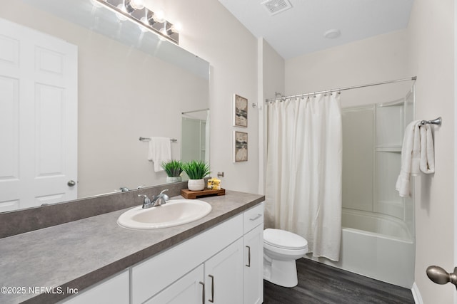 full bathroom featuring shower / bath combo with shower curtain, wood-type flooring, toilet, and vanity