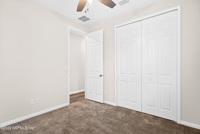 unfurnished bedroom with ceiling fan, a closet, and carpet flooring