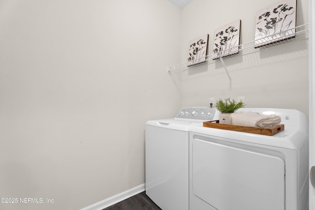 laundry room featuring dark wood-type flooring and separate washer and dryer