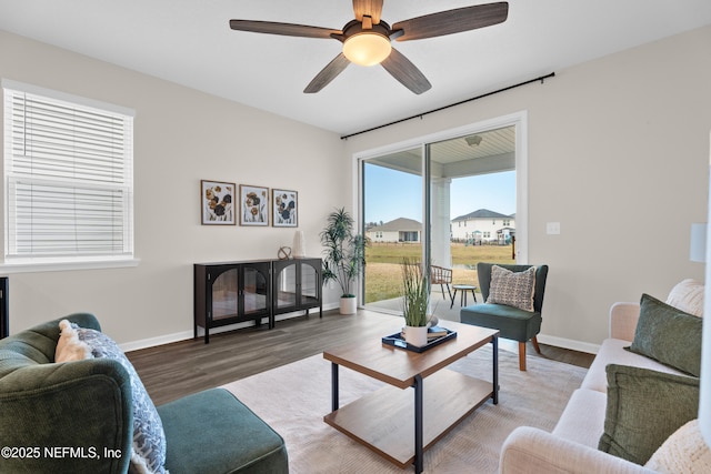 living room featuring hardwood / wood-style flooring and ceiling fan