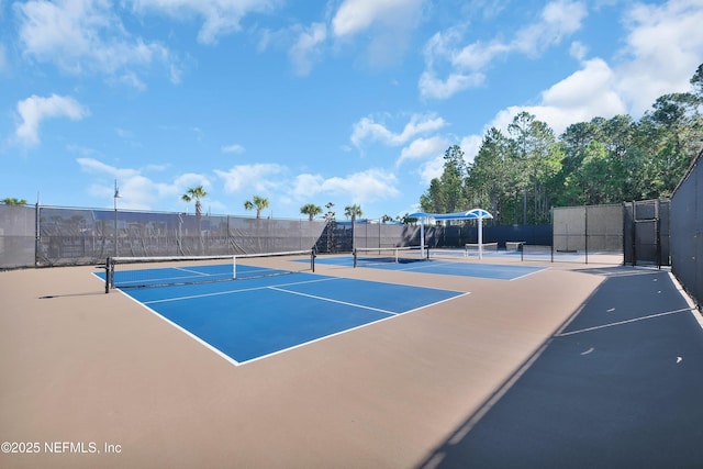 view of tennis court with basketball hoop