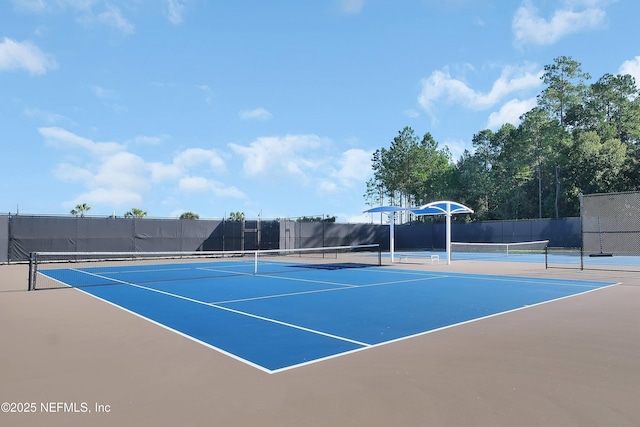 view of tennis court with basketball hoop